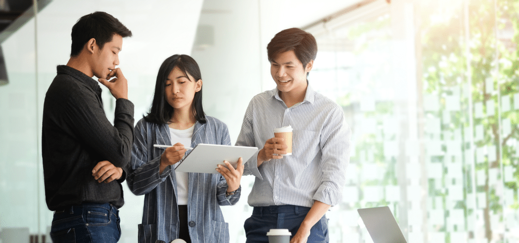 three people in planning meeting coordinating with one another