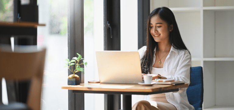 woman working on laptop in a cafe